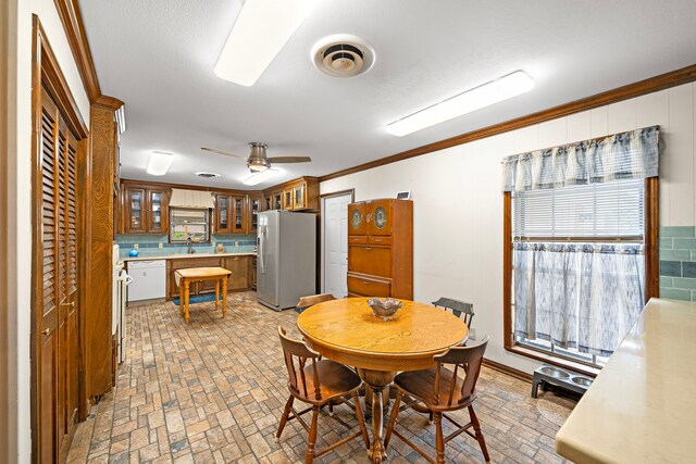 8105 Miller Dr, Hitchcock, TX 77563 - dining area with brick patterned floors, crown molding, and a ceiling fan