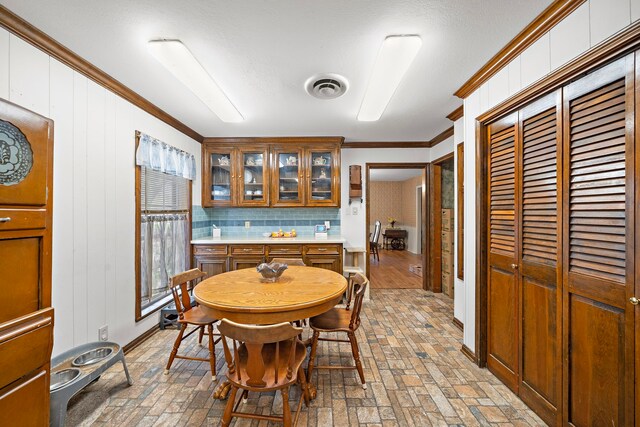 8105 Miller Dr, Hitchcock, TX 77563 - dining area with ornamental molding and brick patterned floors