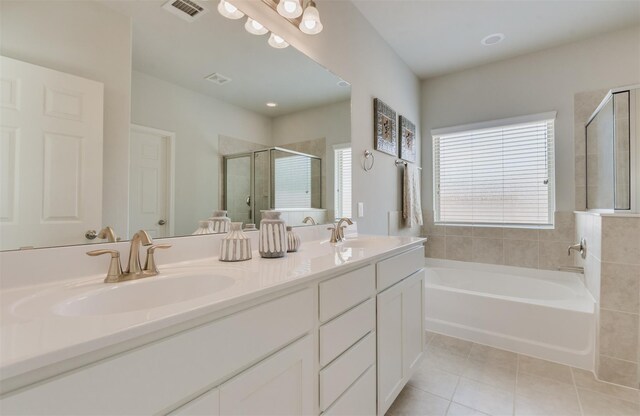 3210 Falling Brook Dr, Baytown, TX 77521 - bathroom with tile patterned floors, a shower stall, healthy amount of natural light, and a garden tub