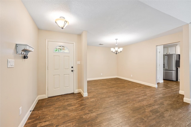 2546 Anzalone Dr, Spring, TX 77373 - entrance foyer with a chandelier and dark wood-style flooring