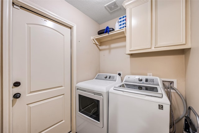 2546 Anzalone Dr, Spring, TX 77373 - washroom featuring cabinet space, washing machine and dryer, and a textured ceiling