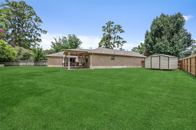 2546 Anzalone Dr, Spring, TX 77373 - back of house featuring a fenced backyard, a patio, brick siding, and a storage unit