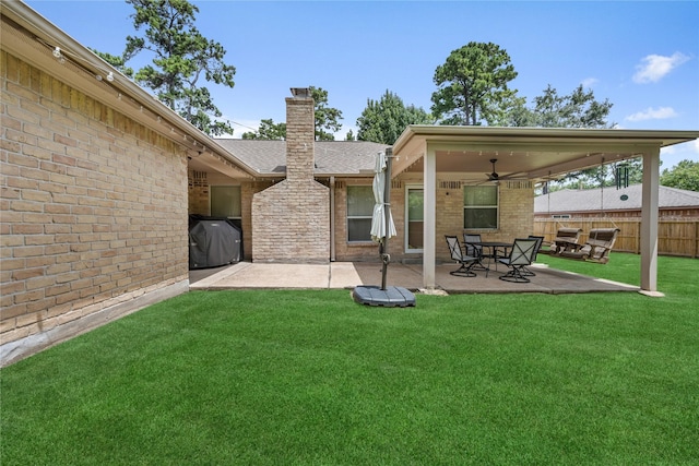 2546 Anzalone Dr, Spring, TX 77373 - rear view of house with ceiling fan, brick siding, a chimney, and a patio
