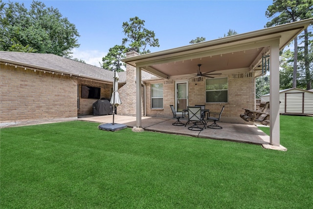 2546 Anzalone Dr, Spring, TX 77373 - rear view of property with ceiling fan, a patio area, a storage shed, and a lawn