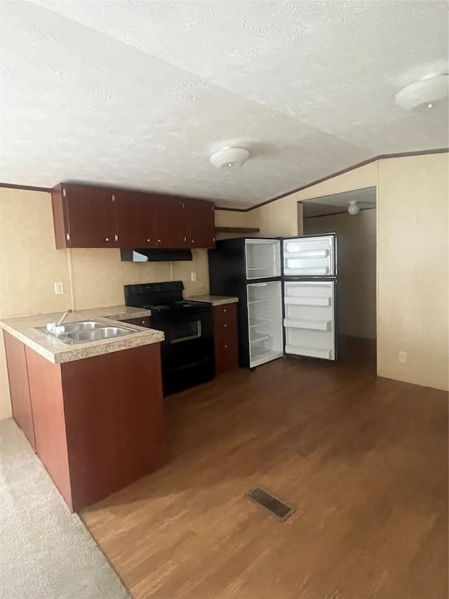 16906 Balmoral, Montgomery, TX 77316 - kitchen featuring black range with electric stovetop, under cabinet range hood, a textured ceiling, dark wood finished floors, and light countertops