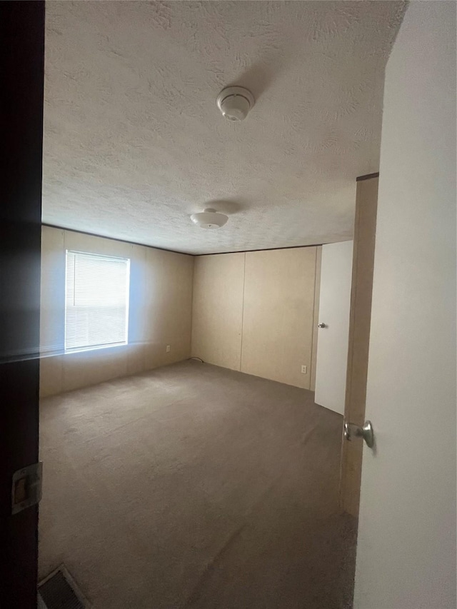 16906 Balmoral, Montgomery, TX 77316 - carpeted spare room with a textured ceiling