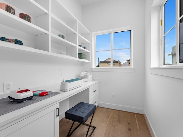 5240 Cornish Unit B, Houston, TX 77007 - home office featuring built in desk, light wood-type flooring, and healthy amount of natural light
