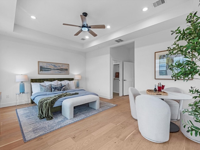 5240 Cornish Unit B, Houston, TX 77007 - bedroom featuring a tray ceiling, recessed lighting, light wood-style flooring, and ceiling fan