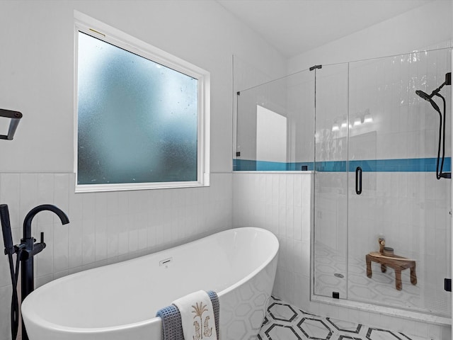 5240 Cornish Unit B, Houston, TX 77007 - bathroom with tile walls, a shower stall, a soaking tub, and a wainscoted wall