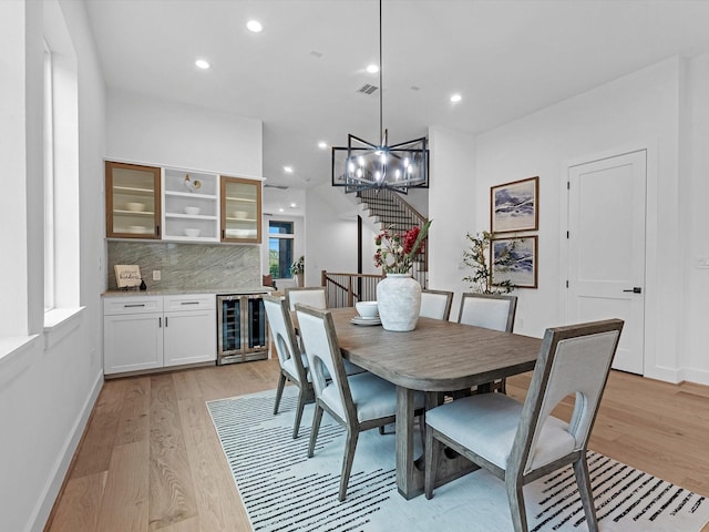 5240 Cornish Unit B, Houston, TX 77007 - dining area with beverage cooler, light wood-style floors, recessed lighting, stairway, and a dry bar
