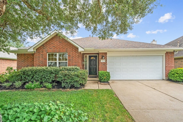5207 Caprock Dr, Pearland, TX 77584 - view of front of home with brick siding, a garage, driveway, and a shingled roof