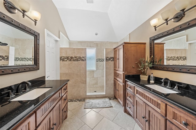 5207 Caprock Dr, Pearland, TX 77584 - full bathroom with vaulted ceiling, walk in shower, two vanities, and tile patterned flooring