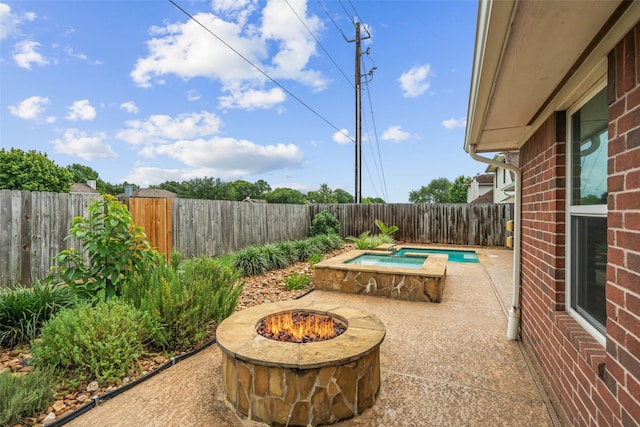 5207 Caprock Dr, Pearland, TX 77584 - fenced backyard featuring an outdoor fire pit, a jacuzzi, and a patio