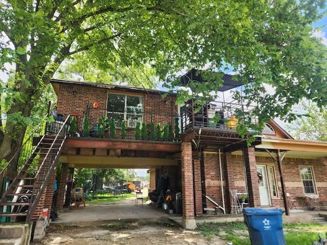 1902 July St, Houston, TX 77093 - view of front facade featuring brick siding, a carport, and stairs