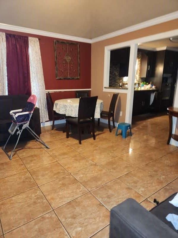 1902 July St, Houston, TX 77093 - dining room with light tile patterned floors and crown molding