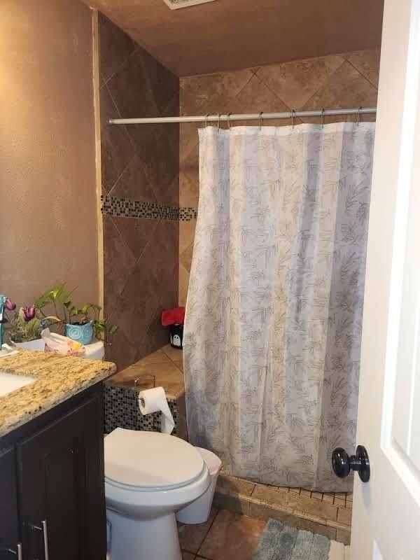 1902 July St, Houston, TX 77093 - bathroom with vanity, tile patterned floors, and a shower with curtain