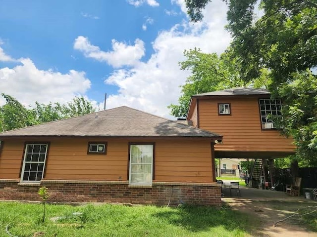 1902 July St, Houston, TX 77093 - back of house featuring brick siding and a shingled roof