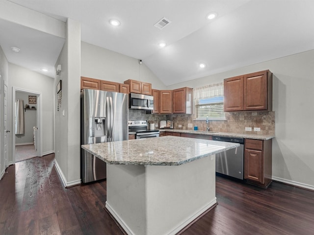 70 Rd 22705, Cleveland, TX 77327 - kitchen featuring appliances with stainless steel finishes, dark wood-type flooring, a center island, tasteful backsplash, and vaulted ceiling