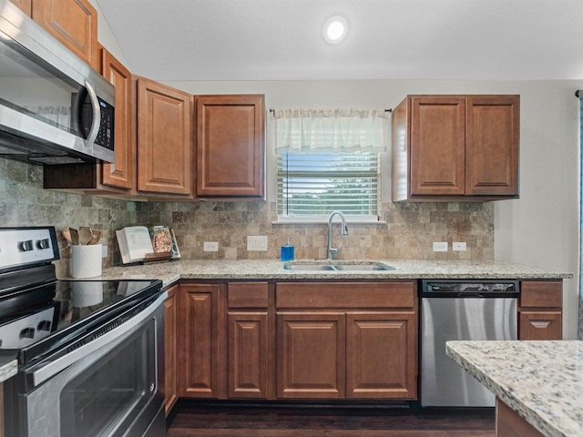 70 Rd 22705, Cleveland, TX 77327 - kitchen featuring appliances with stainless steel finishes, light stone counters, dark wood-style flooring, and decorative backsplash