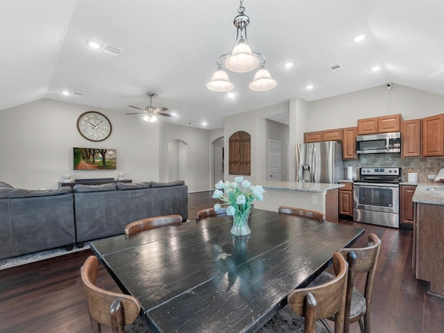70 Rd 22705, Cleveland, TX 77327 - dining space featuring lofted ceiling, a ceiling fan, arched walkways, and dark wood-style floors