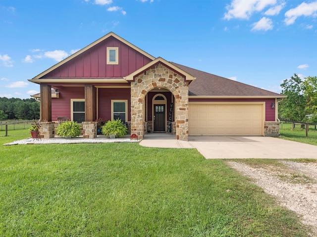 70 Rd 22705, Cleveland, TX 77327 - view of front facade featuring stone siding, concrete driveway, board and batten siding, and a garage