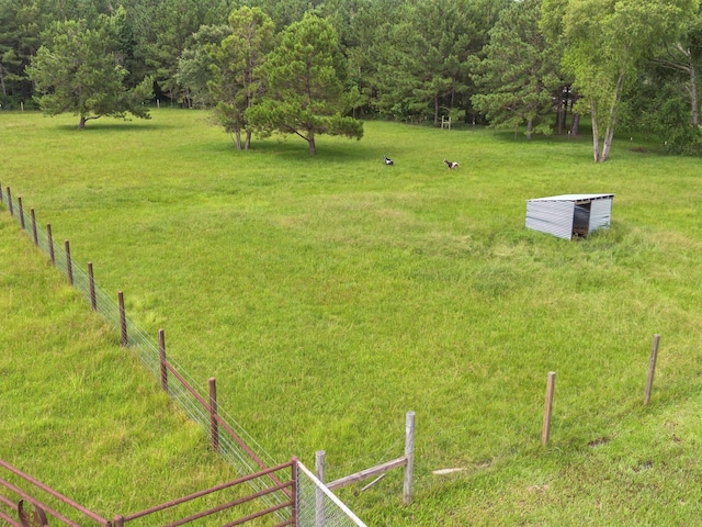 70 Rd 22705, Cleveland, TX 77327 - view of yard featuring a wooded view