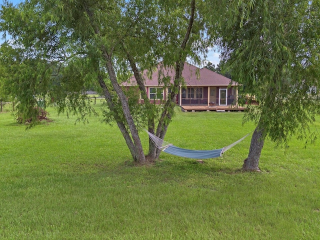 70 Rd 22705, Cleveland, TX 77327 - view of grassy yard featuring a deck and a sunroom