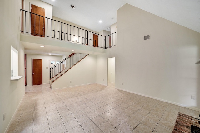 3507 Dawnwood Dr, Spring, TX 77380 - unfurnished living room featuring a towering ceiling, light tile patterned floors, stairs, and recessed lighting
