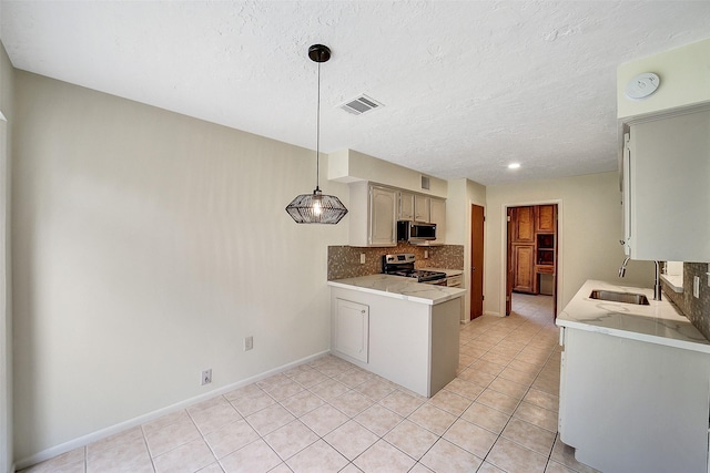 3507 Dawnwood Dr, Spring, TX 77380 - kitchen featuring stainless steel appliances, light countertops, backsplash, light tile patterned floors, and a textured ceiling