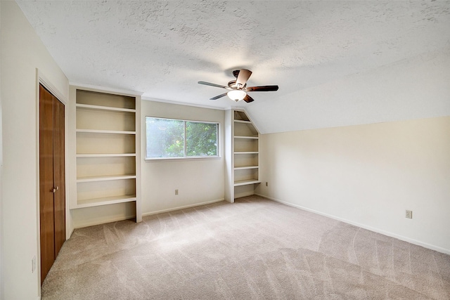 3507 Dawnwood Dr, Spring, TX 77380 - unfurnished bedroom featuring carpet, a textured ceiling, vaulted ceiling, and a ceiling fan