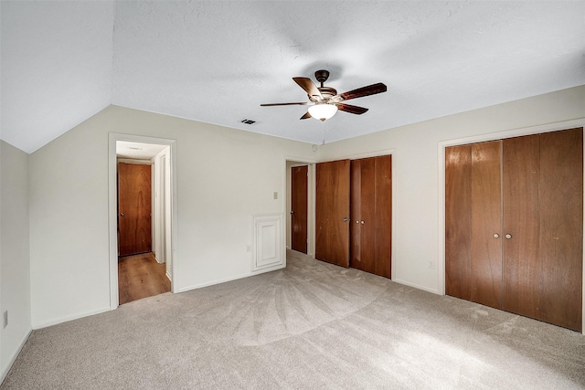 3507 Dawnwood Dr, Spring, TX 77380 - unfurnished bedroom with carpet flooring, two closets, ceiling fan, and lofted ceiling