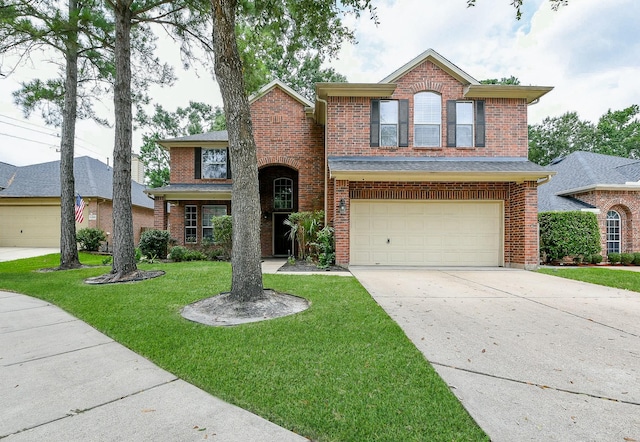 14307 Baron Creek Ln, Houston, TX 77044 - traditional-style house featuring brick siding, a garage, concrete driveway, and a front lawn