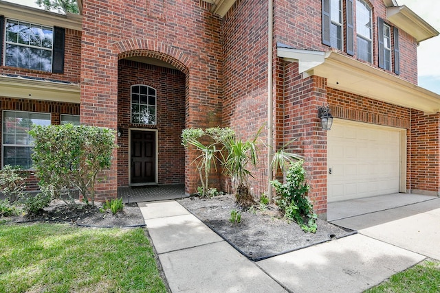 14307 Baron Creek Ln, Houston, TX 77044 - view of exterior entry with a garage and brick siding