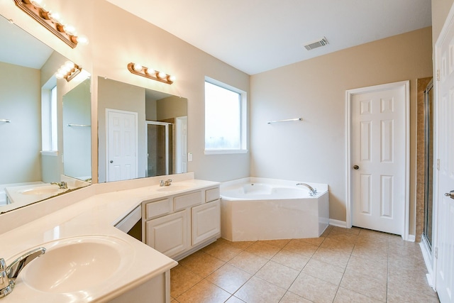 14307 Baron Creek Ln, Houston, TX 77044 - full bathroom with a garden tub, a stall shower, double vanity, and tile patterned floors