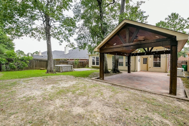 14307 Baron Creek Ln, Houston, TX 77044 - fenced backyard featuring a carport, a patio, a ceiling fan, and a gazebo