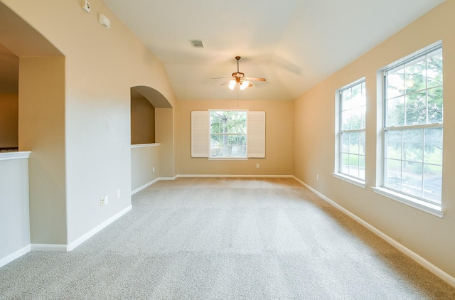 14307 Baron Creek Ln, Houston, TX 77044 - empty room with a ceiling fan, healthy amount of natural light, light carpet, arched walkways, and vaulted ceiling