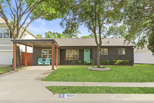 5110 Verdome Ln, Houston, TX 77092 - ranch-style home with driveway, an attached carport, a front lawn, and stone siding