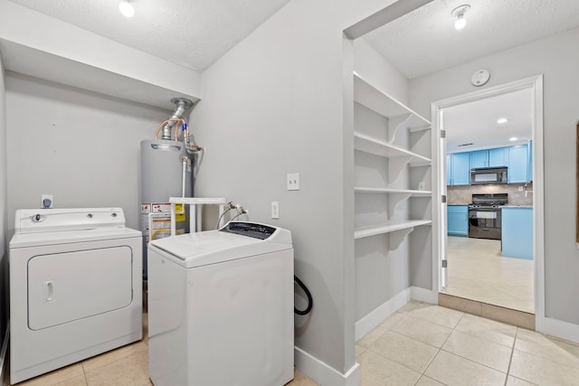 5110 Verdome Ln, Houston, TX 77092 - laundry room with washer and dryer, a textured ceiling, and light tile patterned floors