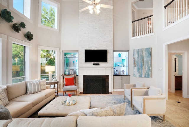 4502 Buffalo Lake Ct, Richmond, TX 77406 - living area with a towering ceiling, a large fireplace, a ceiling fan, and light tile patterned flooring