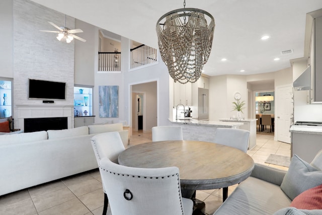 4502 Buffalo Lake Ct, Richmond, TX 77406 - dining space with light tile patterned floors, a ceiling fan, a chandelier, a fireplace, and recessed lighting