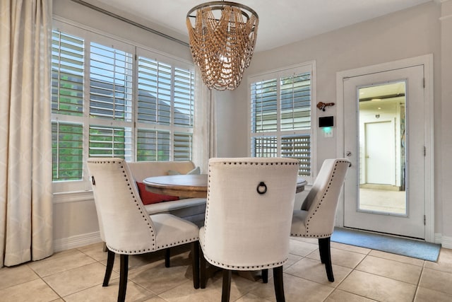 4502 Buffalo Lake Ct, Richmond, TX 77406 - tiled dining area featuring a chandelier and baseboards