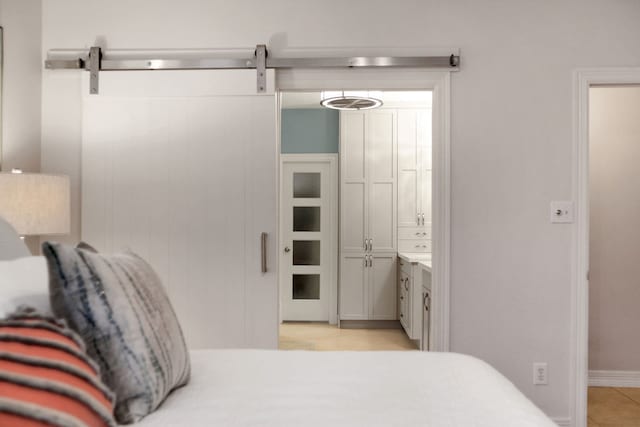 4502 Buffalo Lake Ct, Richmond, TX 77406 - bedroom with a barn door and ensuite bathroom