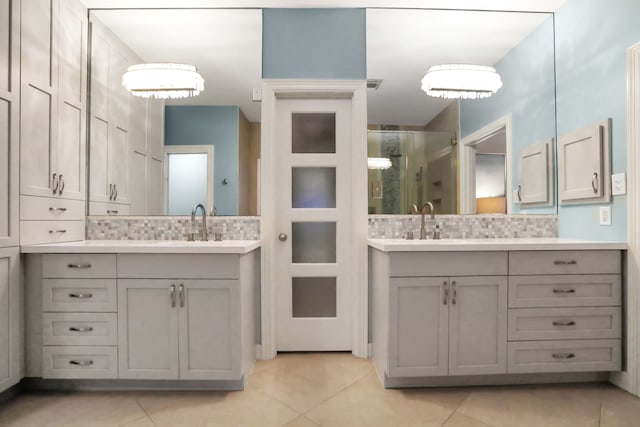4502 Buffalo Lake Ct, Richmond, TX 77406 - bathroom with a shower stall, tile patterned floors, two vanities, and tasteful backsplash