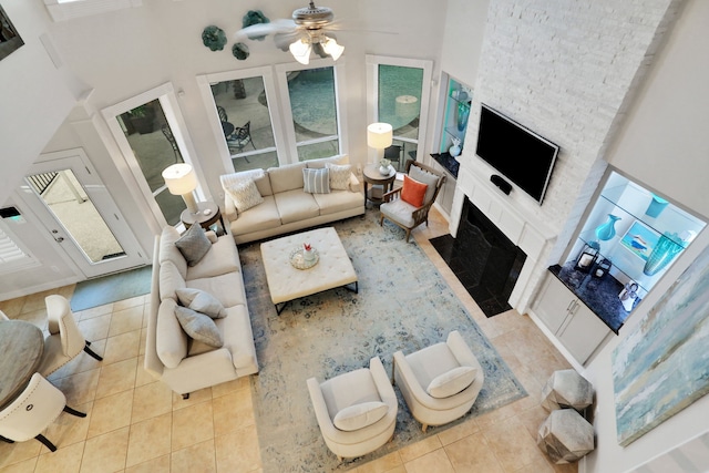 4502 Buffalo Lake Ct, Richmond, TX 77406 - living room with tile patterned floors, a large fireplace, and a ceiling fan