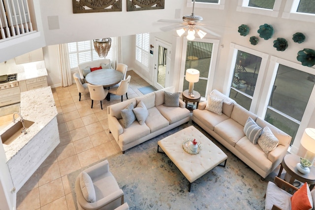 4502 Buffalo Lake Ct, Richmond, TX 77406 - living area featuring light tile patterned flooring, a high ceiling, and a ceiling fan