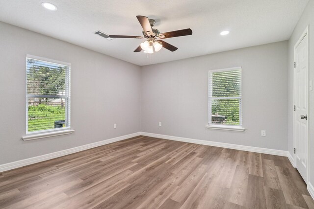 16820 Laurelwood Dr, Channelview, TX 77530 - empty room featuring plenty of natural light, a ceiling fan, wood finished floors, and recessed lighting