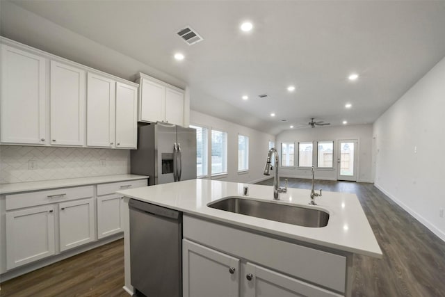 19172 Cedar Lennox Cir, Magnolia, TX 77355 - kitchen featuring appliances with stainless steel finishes, dark wood-style flooring, white cabinets, and recessed lighting
