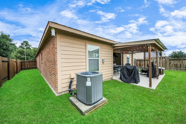 38327 Miranda Ln, Magnolia, TX 77355 - back of house featuring a fenced backyard, a patio area, and brick siding