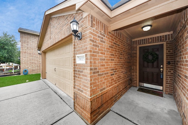 38327 Miranda Ln, Magnolia, TX 77355 - doorway to property featuring brick siding, driveway, and an attached garage