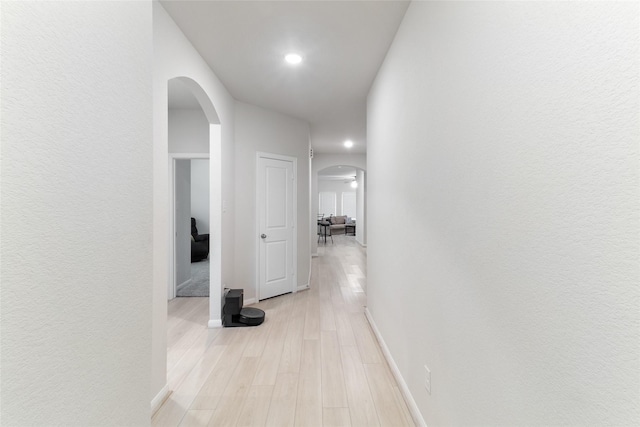 214 Water Grass Trl, Clute, TX 77531 - corridor with arched walkways, light wood finished floors, and recessed lighting